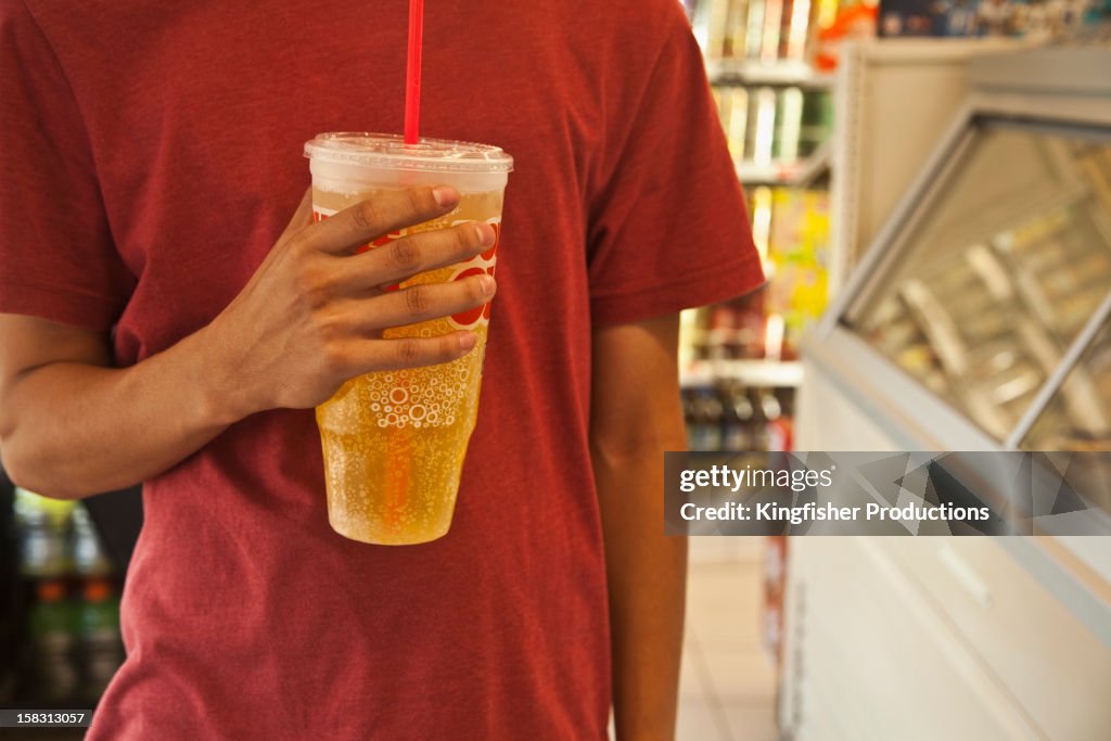 Caucasian man holding soda