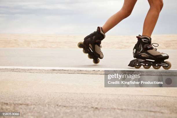caucasian teenager roller blading - skaten stockfoto's en -beelden