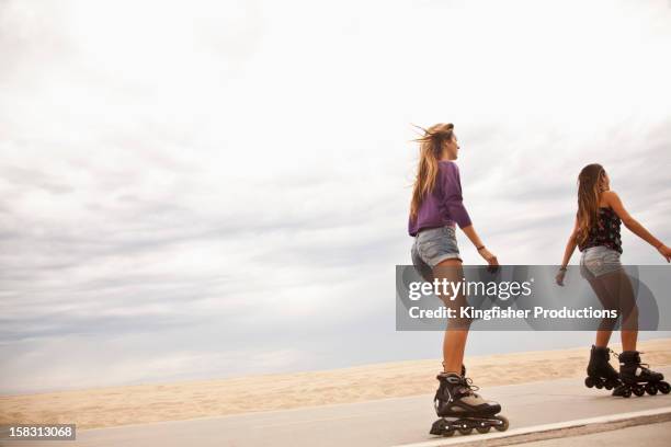 caucasian teenage girls roller blading - inline skating stock pictures, royalty-free photos & images