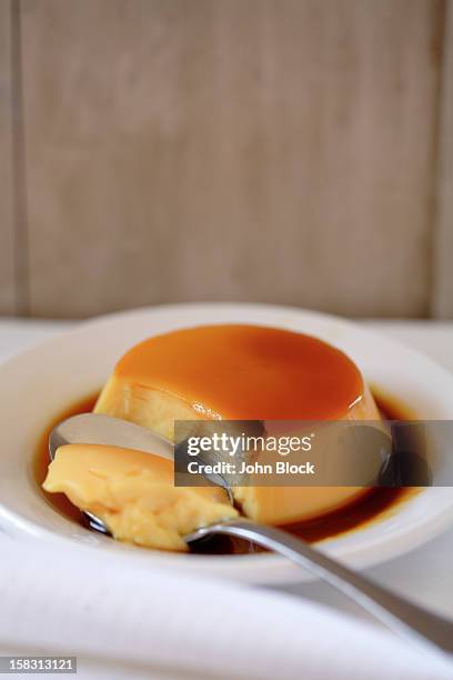 flan on plate with spoon - flan stock pictures, royalty-free photos & images