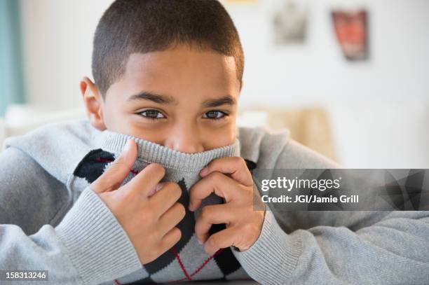 hispanic boy hiding his face - hands covering mouth stock pictures, royalty-free photos & images