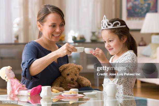 caucasian mother and daughter having tea party - doll fotografías e imágenes de stock