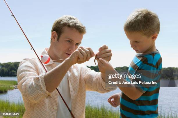 caucasian father and son fishing - fishing float stock pictures, royalty-free photos & images