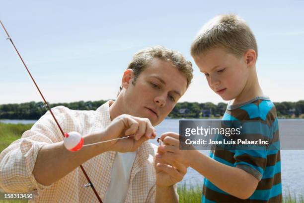 caucasian father and son fishing - fishing hook worm stock pictures, royalty-free photos & images