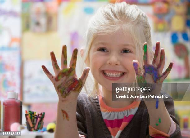 caucasian girl with paint on hands - 4 girls finger painting stock pictures, royalty-free photos & images