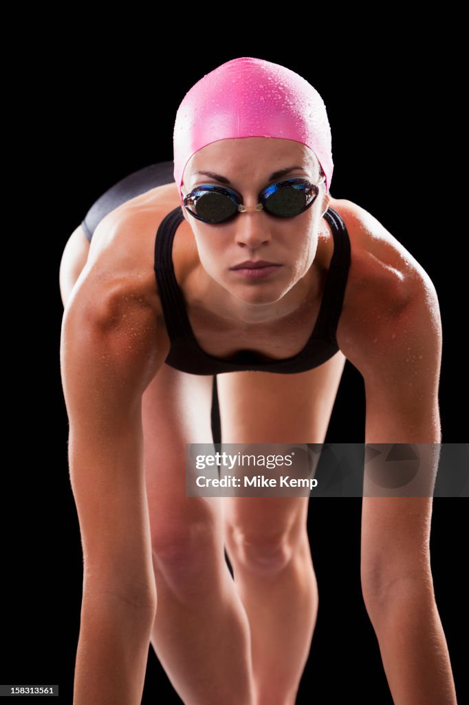 Caucasian swimmer in swim cap and goggles