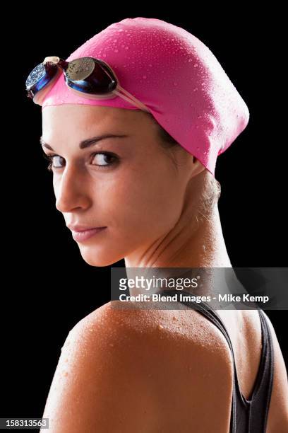 caucasian swimmer in swim cap and goggles - studio portrait swimmer photos et images de collection