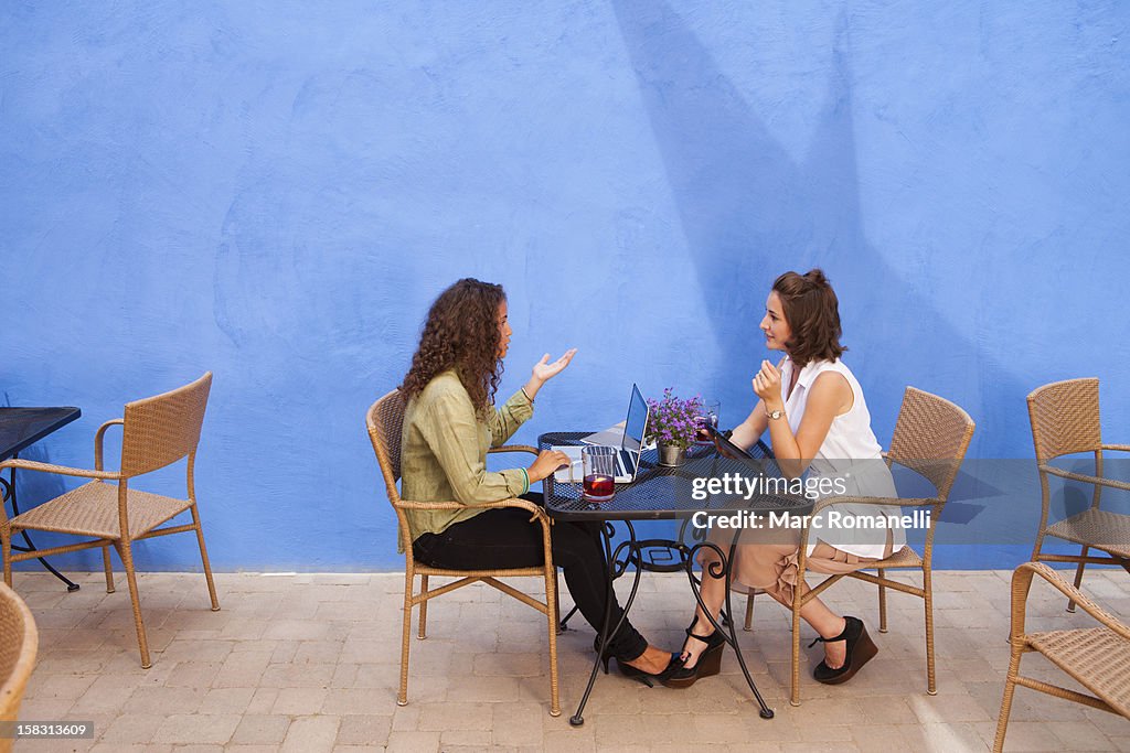 Businesswomen having meeting in outdoor cafe