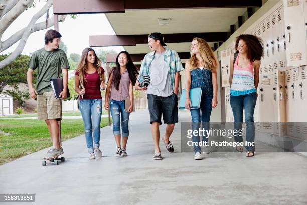 school friends walking in portico - sports hall stock pictures, royalty-free photos & images