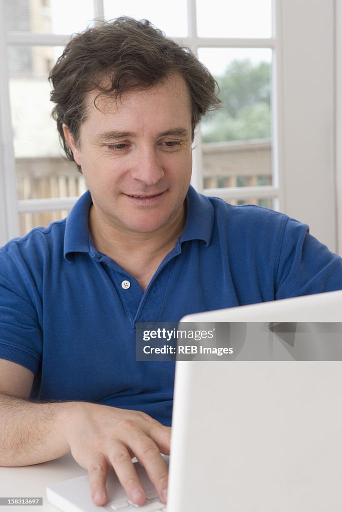 Caucasian man using laptop