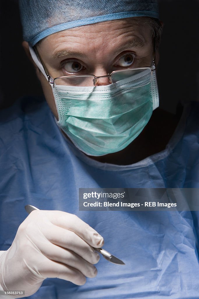 Caucasian surgeon performing surgery