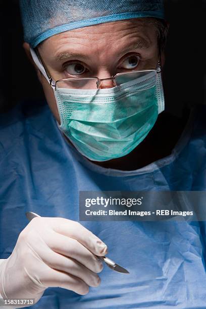 caucasian surgeon performing surgery - scalpel stock pictures, royalty-free photos & images