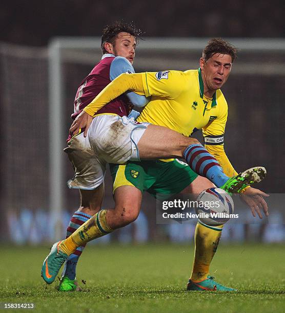 Chris Herd of Aston Villa challenges Grant Holt of Norwich City during the Capital One Cup Quarter Final match between Norwich City and Aston Villa...