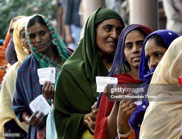 Voters standing in queue during the first phase polling of Gujarat assembly election at Dholka on December 13, 2012 in Ahmedabad, India.