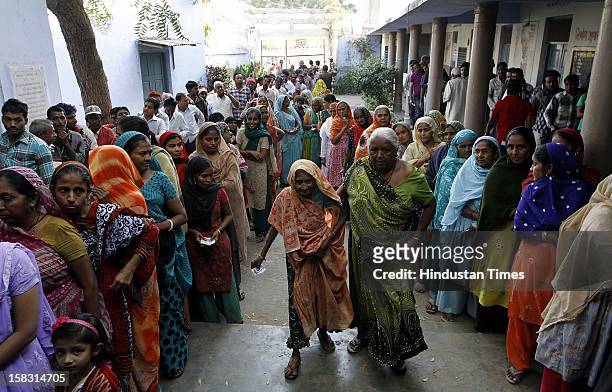 Voters standing in queue during the first phase polling of Gujarat assembly election at Dholka on December 13, 2012 in Ahmedabad, India.