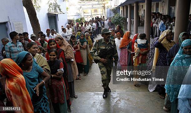 Voters standing in queue during the first phase polling of Gujarat assembly election at Dholka on December 13, 2012 in Ahmedabad, India.