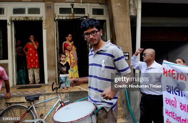 People of the surat requesting youngsters to cast their votes during the first phase polling of Gujarat assembly elections on December 13, 2012 in...