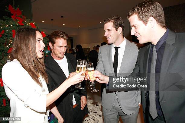 Host Louise Roe, Actor Jason Lewis, Cameron Winklevoss and Tyler Winklevoss toast at the Hukkster Holiday Party Hosted by Louise Roe and Founders...