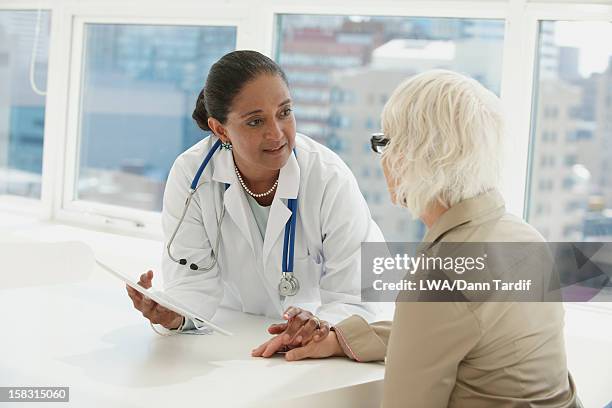 indian doctor talking with patient - clinic canada diversity stock-fotos und bilder