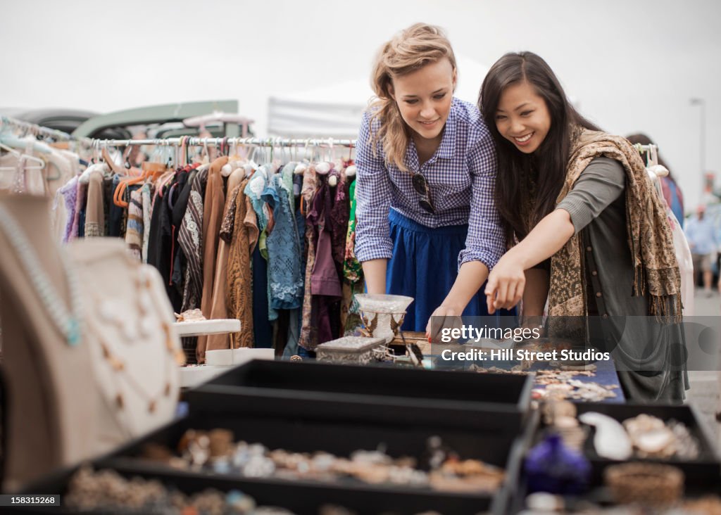 Friends shopping for jewelry in flea market