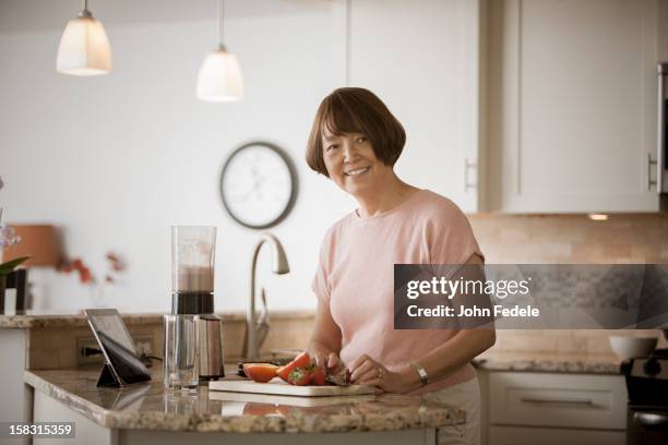 asian woman preparing food - asian cooking stock-fotos und bilder