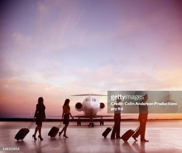 pilots and flight staff walking near jet - flight attendants stock-fotos und bilder