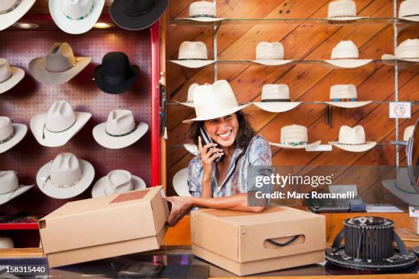 ecuadorian woman working in hat store - cowboy hat shop stock pictures, royalty-free photos & images