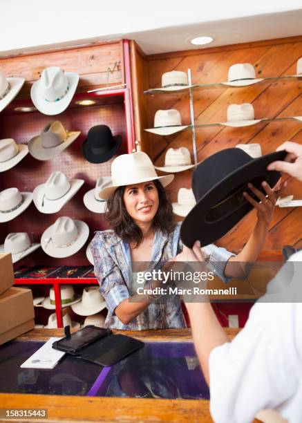 ecuadorian woman working in hat store - cowboy hat shop stock pictures, royalty-free photos & images