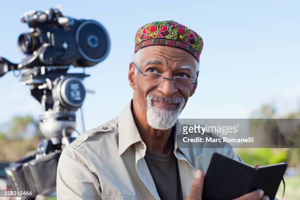 african american director near film camera - film director stock-fotos und bilder