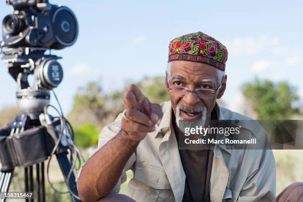 african american director near film camera - film director stock-fotos und bilder