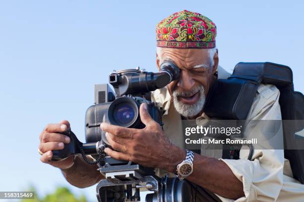 african american man using film camera - directing film stock pictures, royalty-free photos & images