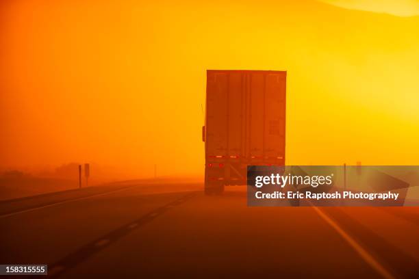 truck driving down road in dust storm - dust storm stock-fotos und bilder