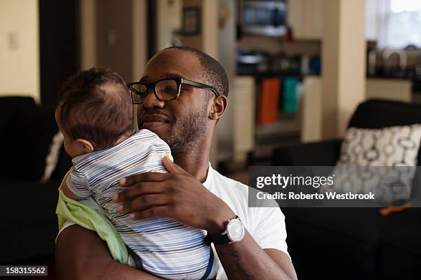 father holding baby - burping stock-fotos und bilder