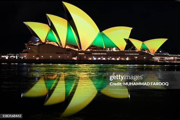 The Sydney Opera House is illuminated in green and gold in Sydney on August 7 to support the Australia's women's football team ahead of their first...