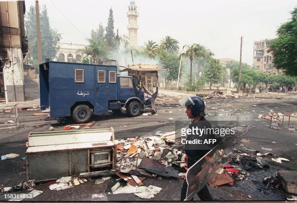 Riot policeman patrols among debris in Tizi-Ouzou 27 June, following riots in which an 18 year-old was killed and several people injured. Protests...