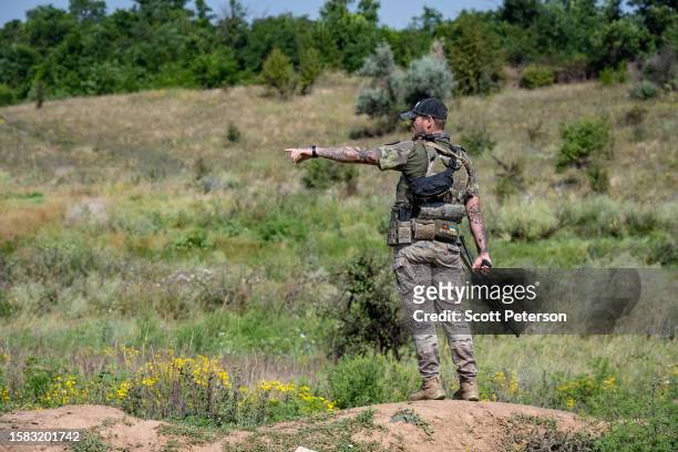 Ukrainian soldiers of the 128th Brigade of the Territorial Defense pause from their duties on the southern counteroffensive frontline to refresh...