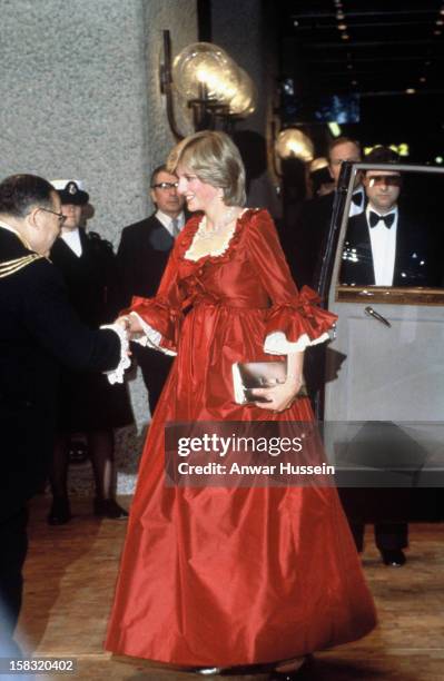 Pregnant Princess Diana, Princess of Wales in a red David Sassoon maternity gown attending a function at the Barbican Centre on March 30, 1982 in...