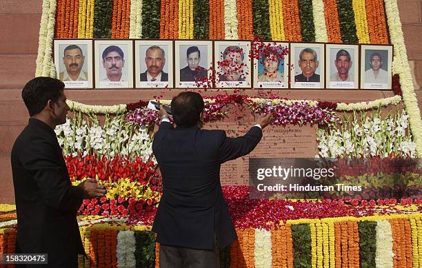 An Indian parliament officer pays floral tribute to colleagues who lost their lives in the 2001 attack on India's parliament during an event to mark...