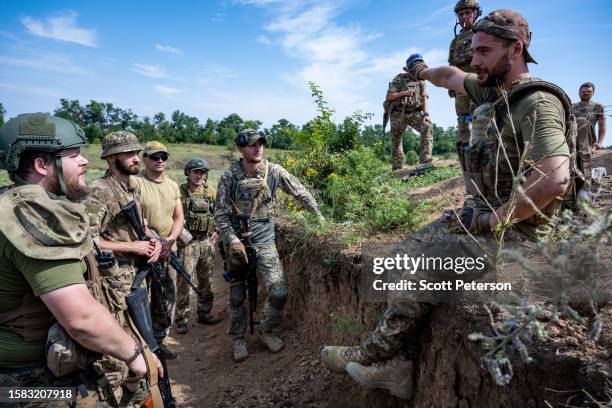 Ukrainian soldiers of the 128th Brigade of the Territorial Defense pause from their duties on the southern counteroffensive frontline to refresh...