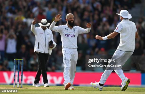 Moeen Ali of England celebrates the wicket of Pat Cummins of Australia with team mate Stuart Broad during Day Five of the LV= Insurance Ashes 5th...