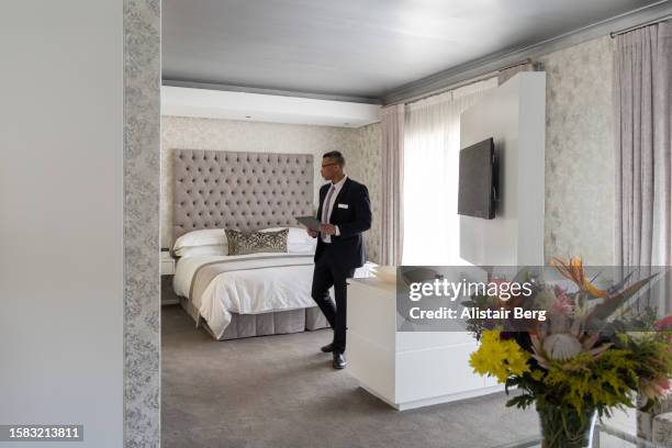 hotel manager doing inspection of a luxury suite - turismo responsable fotografías e imágenes de stock