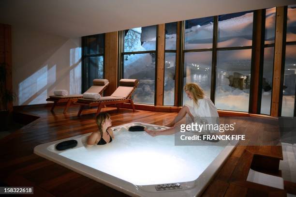 Women enjoy the jacuzzi of the luxury hotel "Les Barmes de l'Ours", taken on December 13, 2012 in Val d'Isere, French Alps. AFP PHOTO / FRANCK FIFE