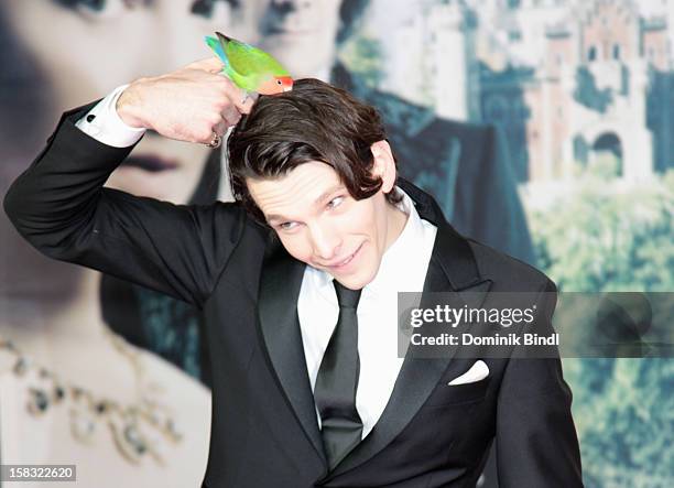 Sabin Tambrea poses with a bird at Ludwig II - Germany Photocall at HVB Forum on December 13, 2012 in Munich, Germany.