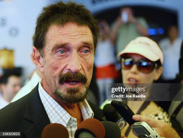 John McAfee talks to the media outside Beacon Hotel where he is staying after arriving last night from Guatemala on December 13, 2012 in Miami Beach,...