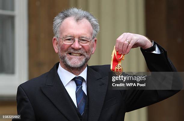 Sir Tony Cunningham holds his Knighthood medal which was awarded to him by Queen Elizabeth II during an Investiture ceremony at Buckingham Palace on...