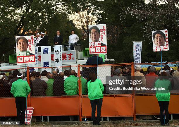 Japan's main opposition Liberal Democratic Party supporters hold up placards in support of party leader its leader Shinzo Abe's during party election...