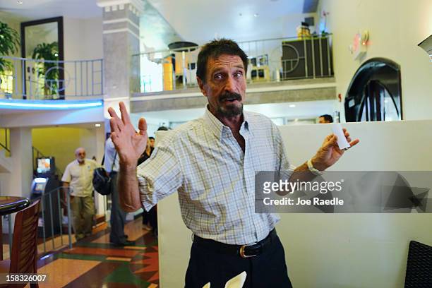 John McAfee talks to the media at the Beacon Hotel where he is staying after arriving last night from Guatemala on December 13, 2012 in Miami Beach,...