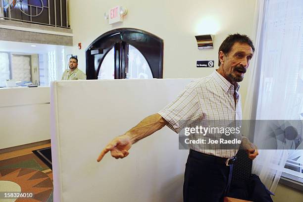 John McAfee talks to the media at the Beacon Hotel where he is staying after arriving last night from Guatemala on December 13, 2012 in Miami Beach,...