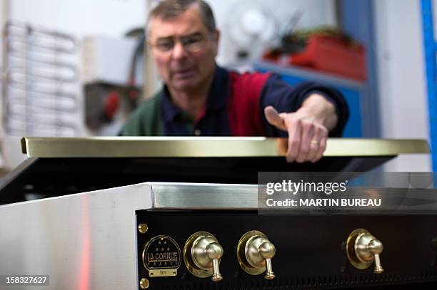 An employee of French cooker maker "La Cornue" works in the factory on December 13 in Saint-Ouen-l'Aumone, north of Paris. AFP PHOTO / MARTIN BUREAU