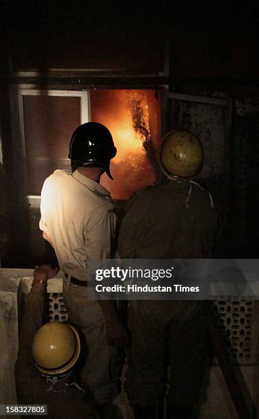 Fire fighters douse a fire at a godown in Bhagirath Palace, an electrical market of Chandni Chowk area, on December 13, 2012 in New Delhi, India. The...